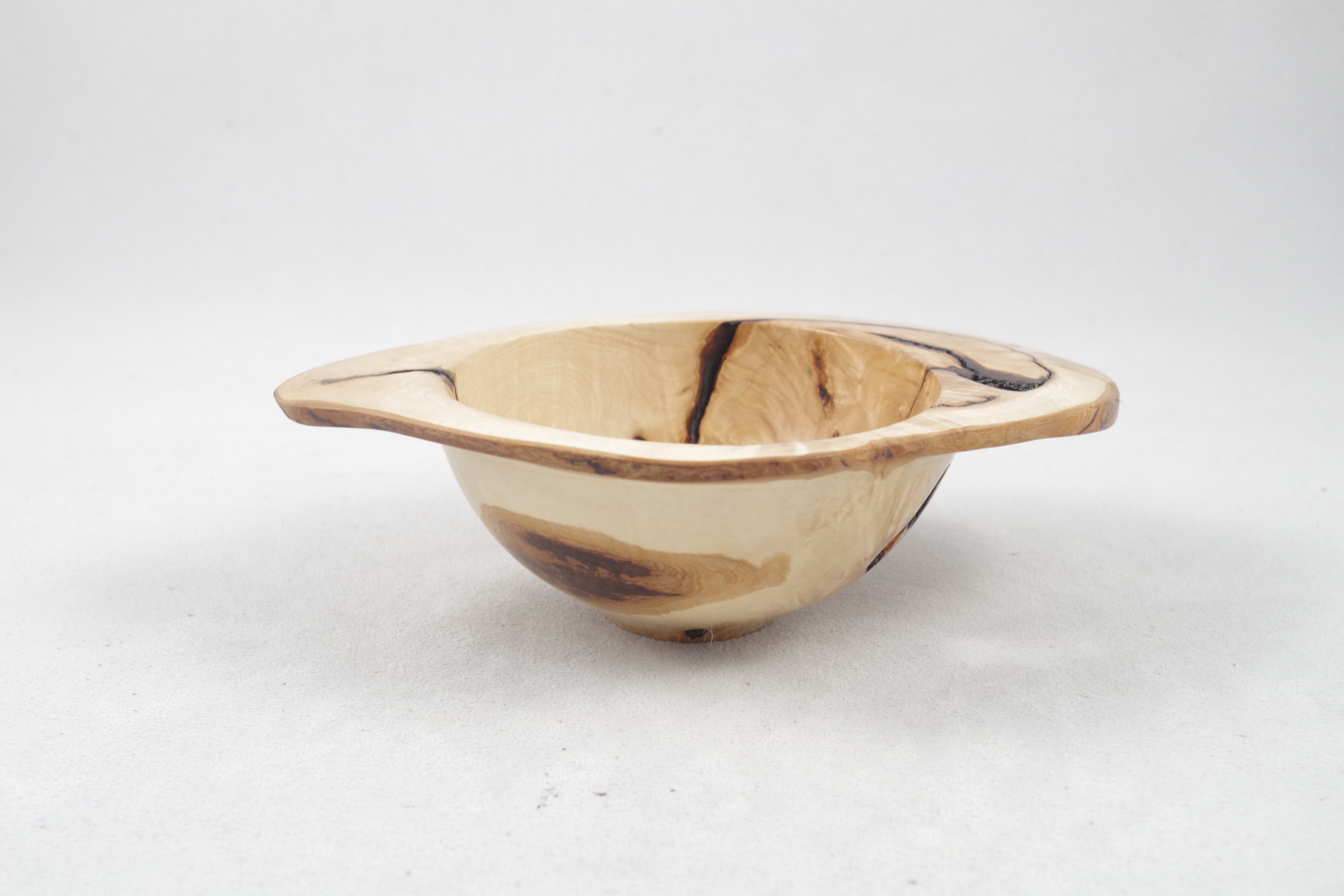Natural edge burl bowl side